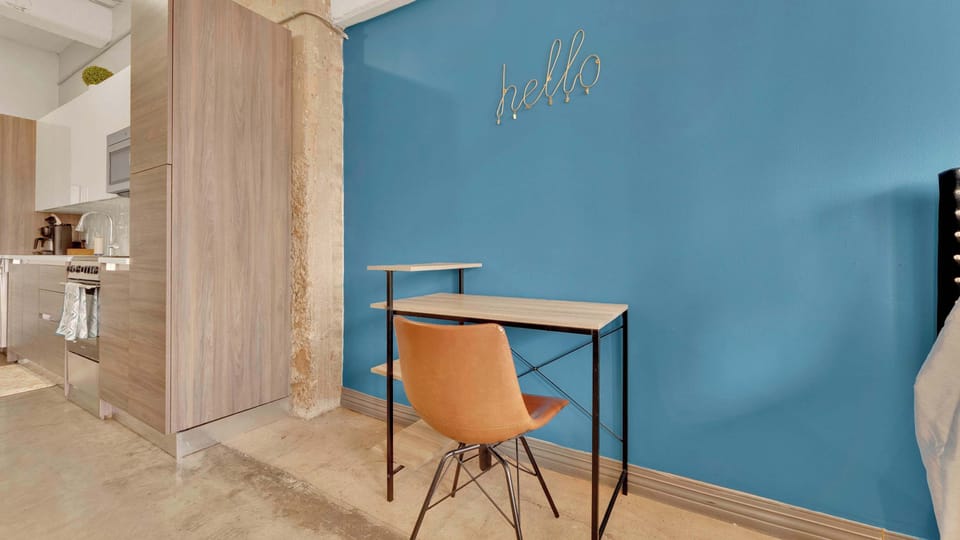 Home Office: Bright blue wall and sleek desk create the perfect space for work or inspiration!
