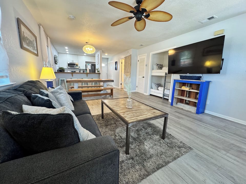 Living room with a couch and twin-size bunk beds  