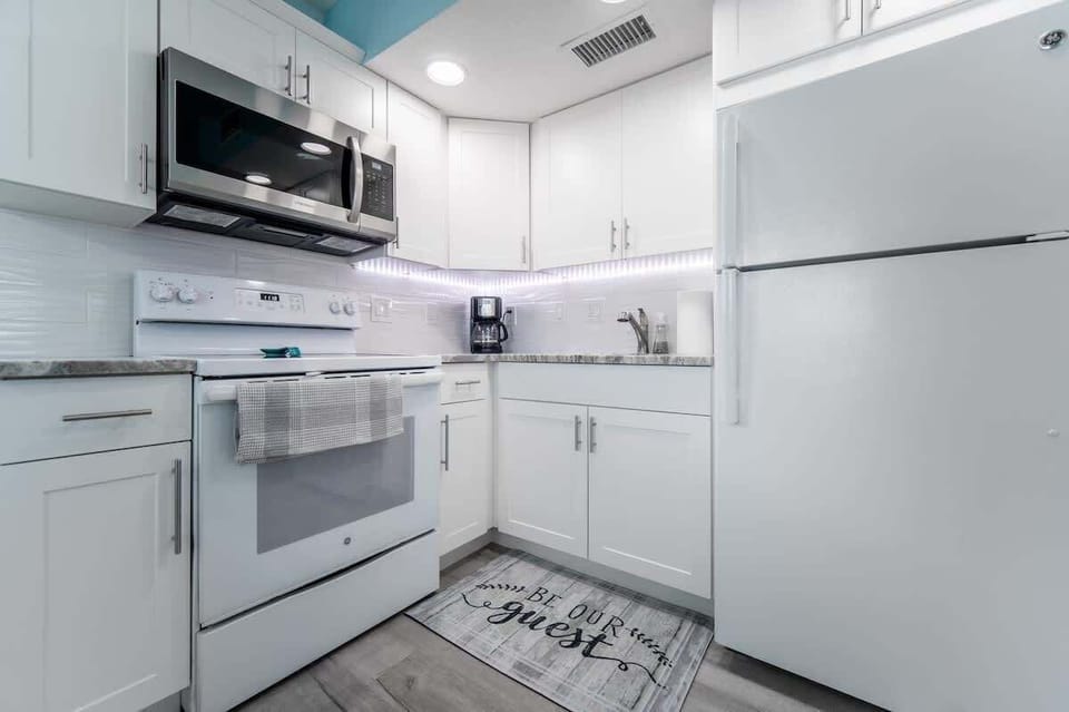 Full kitchen with oven, microwave, fridge, freezer, drip coffee maker, glasses, silverware, pans, plates, etc. 