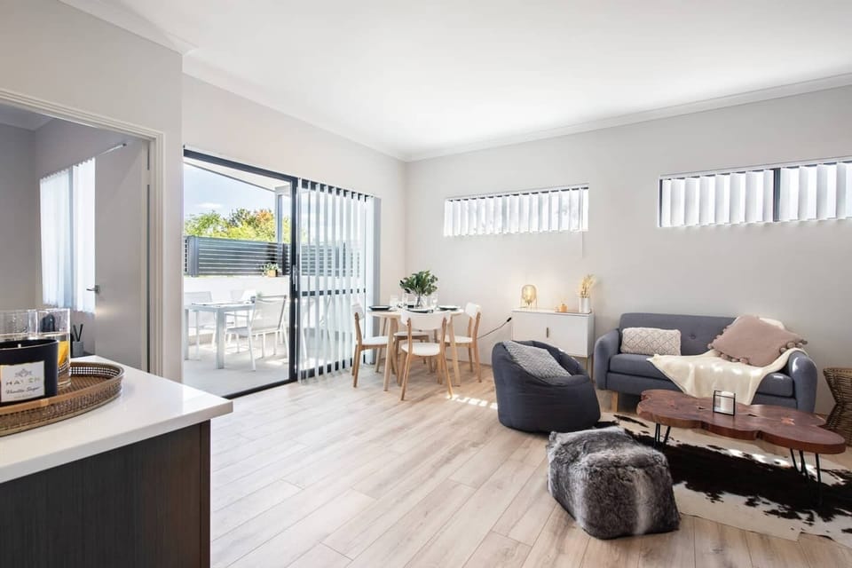 Light-filled and spacious, this inviting living room opens onto the balcony, seamlessly blending indoor comfort with outdoor living.