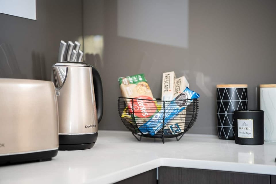 Thoughtfully stocked kitchen corner with a kettle, essentials, and welcoming snack basket.