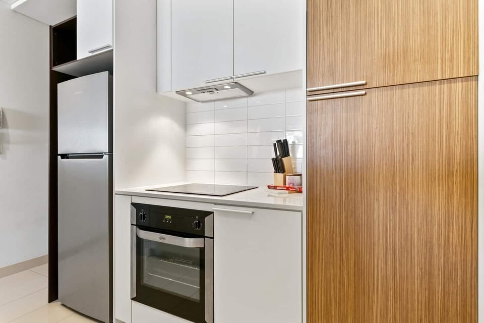 Modern kitchen with cooktop and oven.