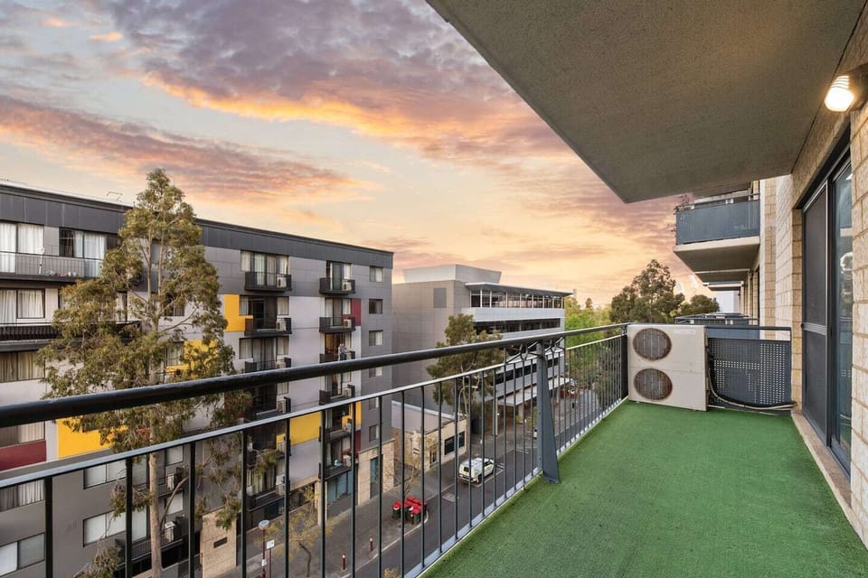 Enjoy the beautiful skies from your private balcony, overlooking the urban landscape.