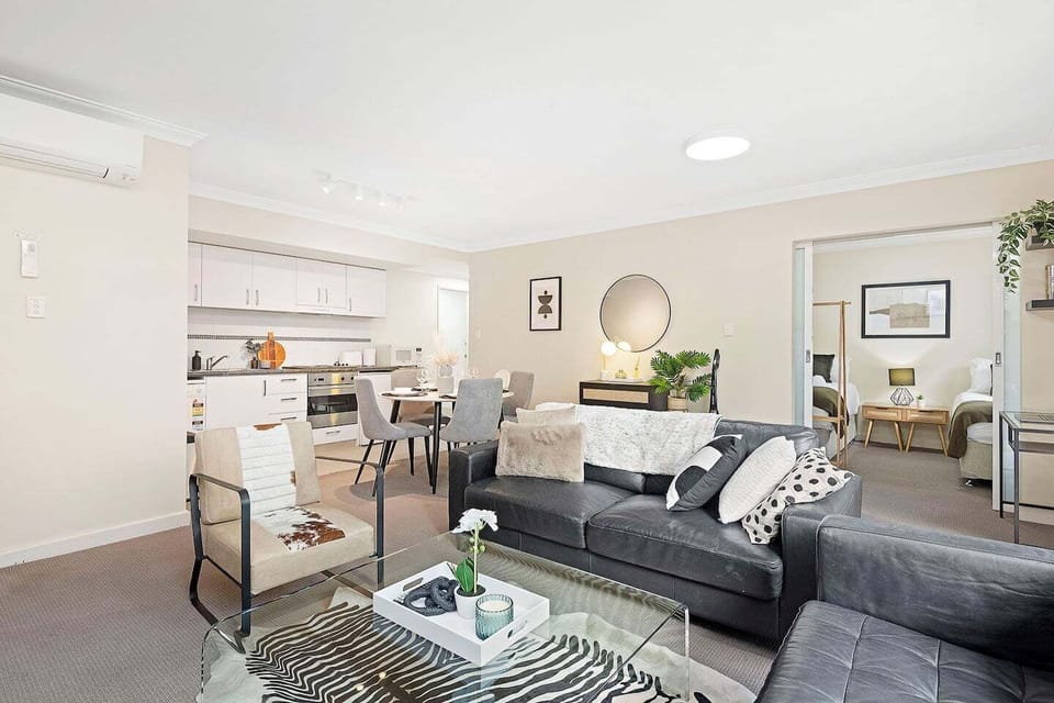 Welcome to your modern home away from home! This bright area seamlessly connects a comfortable lounge, fully equipped kitchen, and dining space.