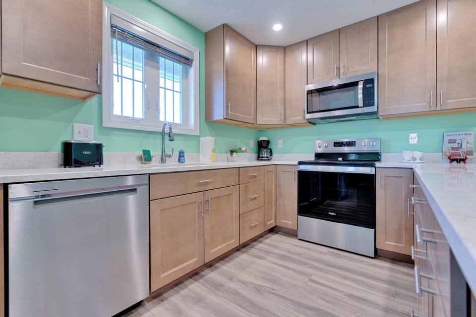 Unit A  - full modern kitchen 
Michelle said on her Sept 2024 VRBO review "Beautiful home and a great location. Great layout for the entire family to visit. Love that it has 3 full bathrooms. Being able to walk across the street to the beach was perfect. It was cool watching the trains go by too. The best part was since the house is not located near an intersection, the horns did not go off."