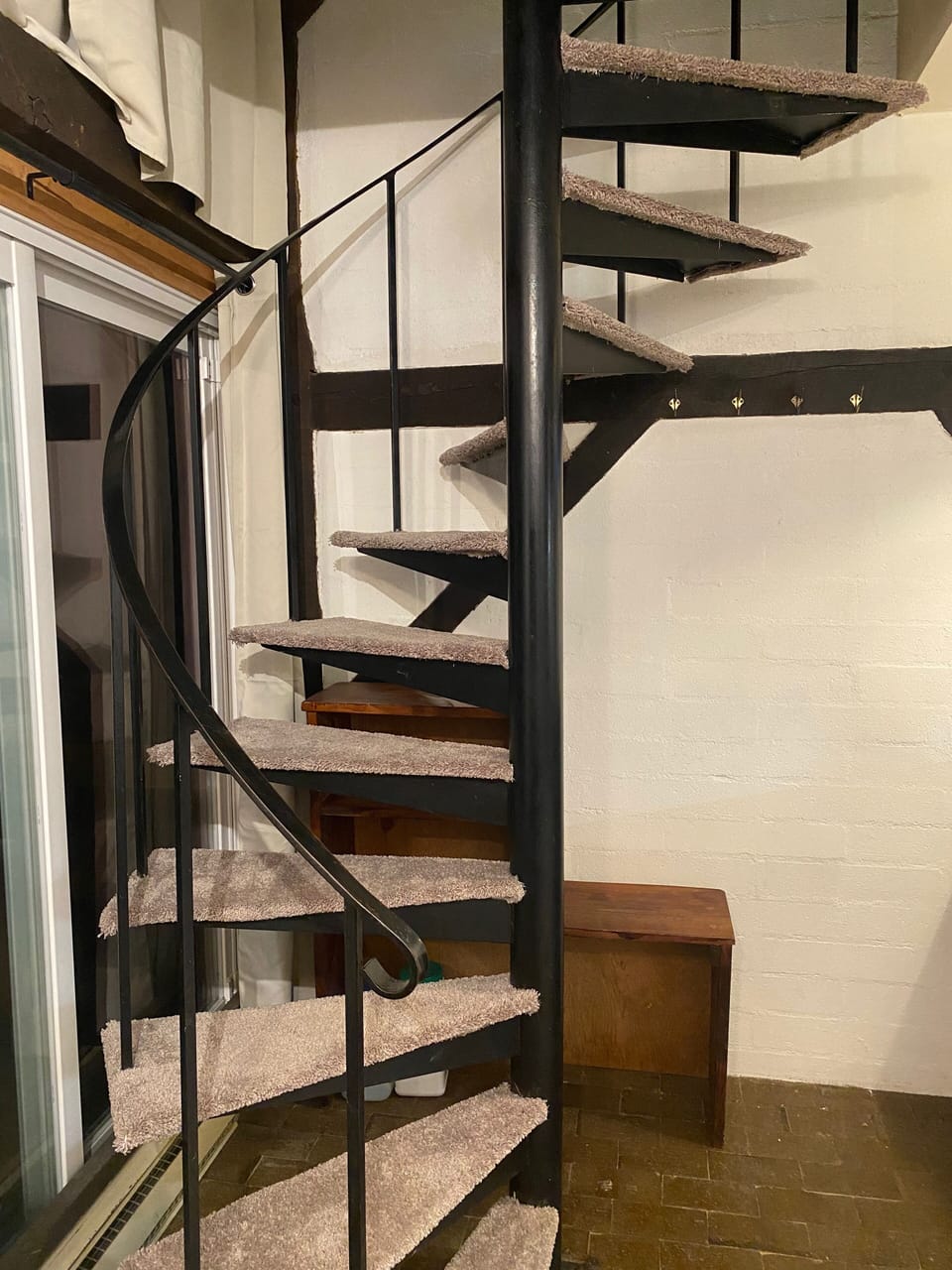 Spiral staircase to upstairs bedroom(s)