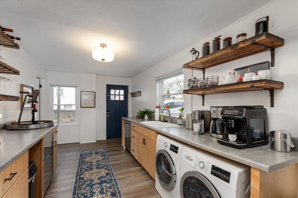 You will enter through our Welcome Room equipped with Coffee Bar,  Wine Bar and beverage fridge. Small laundry to the right.