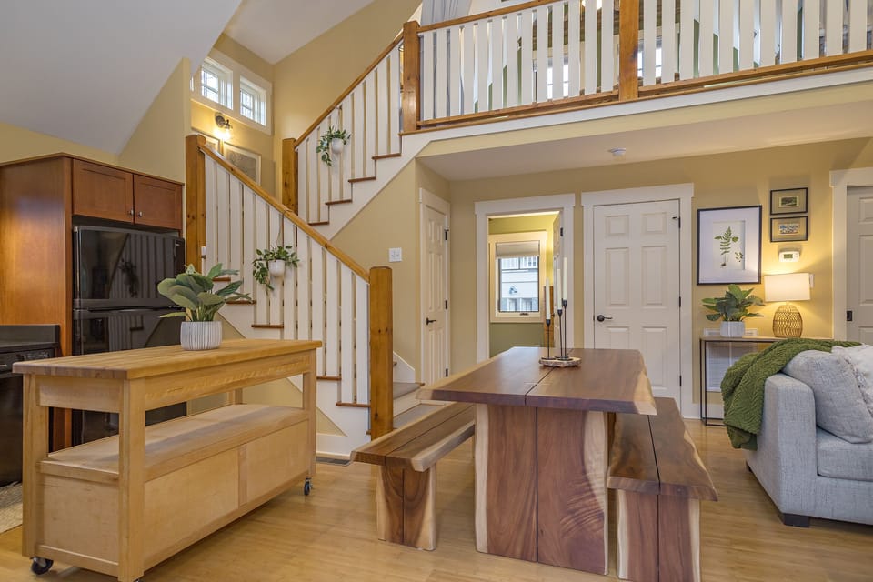 Open dining area & living room with electric fireplace & Smart TV with streaming.