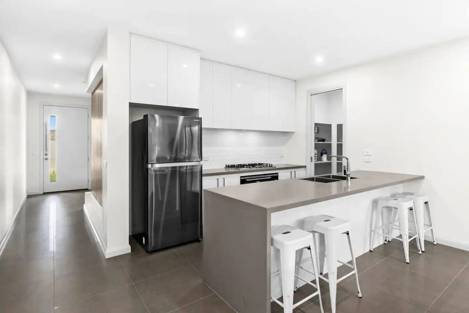 Fully equipped kitchen complete with modern appliances and walk-in pantry.
