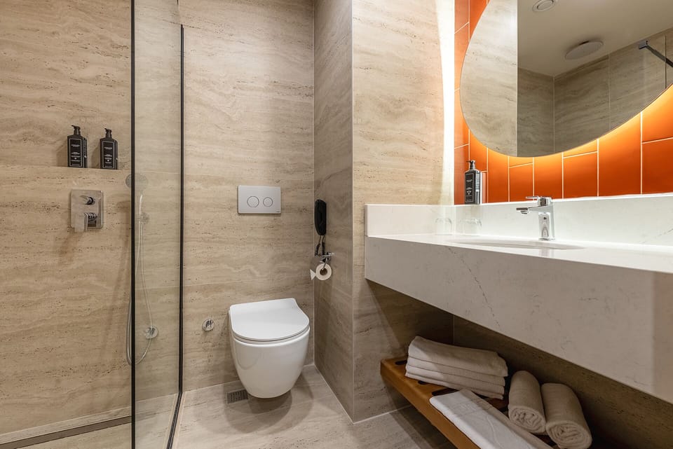 Suite, City View | Bathroom | Shower, hair dryer, slippers, towels