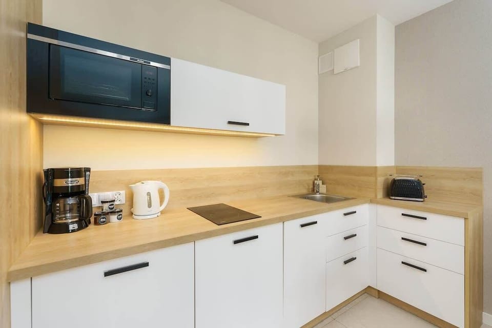 The sleek design of the kitchenette blending seamlessly with the living area.