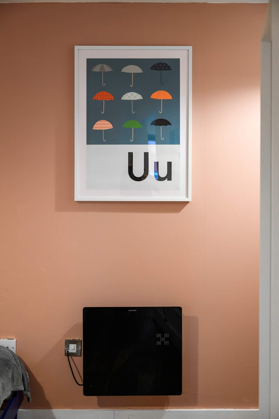 Playful umbrella artwork on the bedroom wall, a nod to the apartment name and a Manchester classic