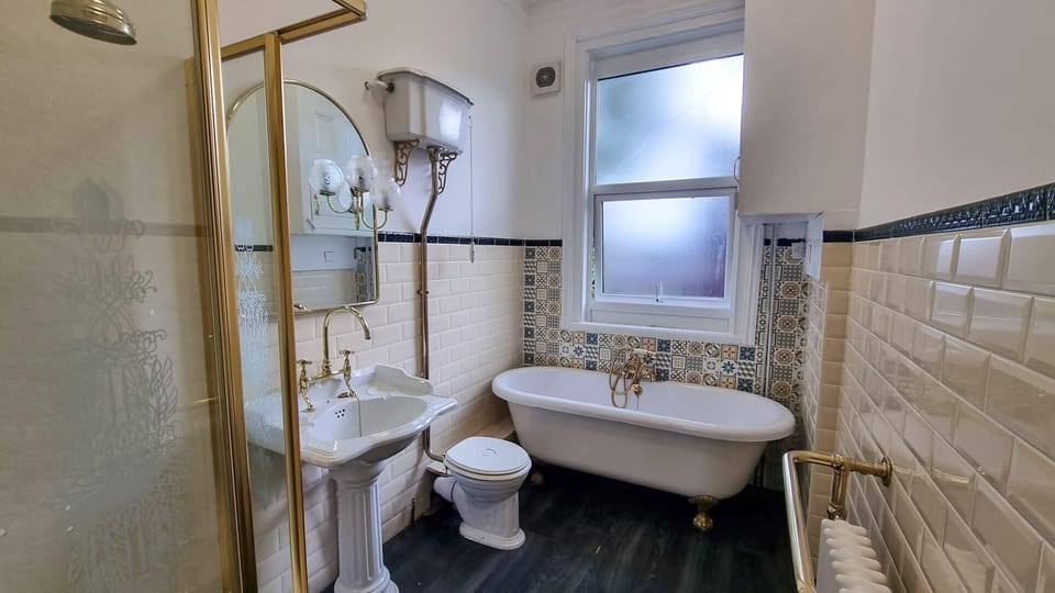 Elegant bathroom with bathtub, perfect for a long soak after a day exploring Manchester