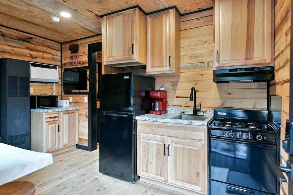 A small kitchenette with a microwave and white cabinetry.
