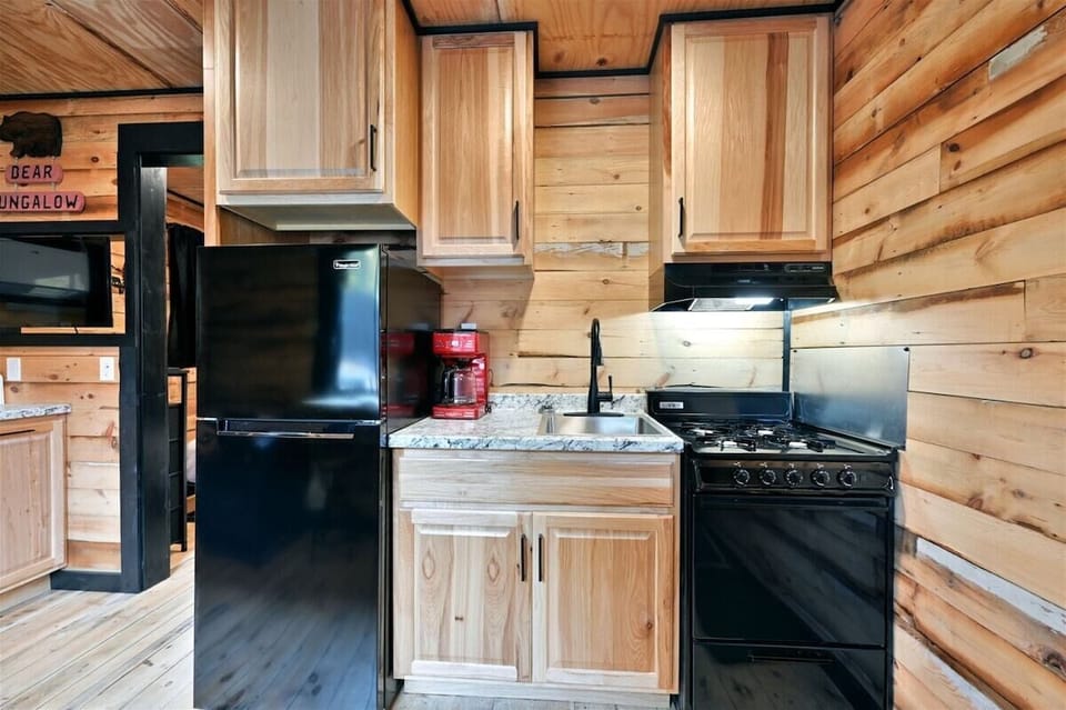 A small kitchenette with a microwave and white cabinetry.
