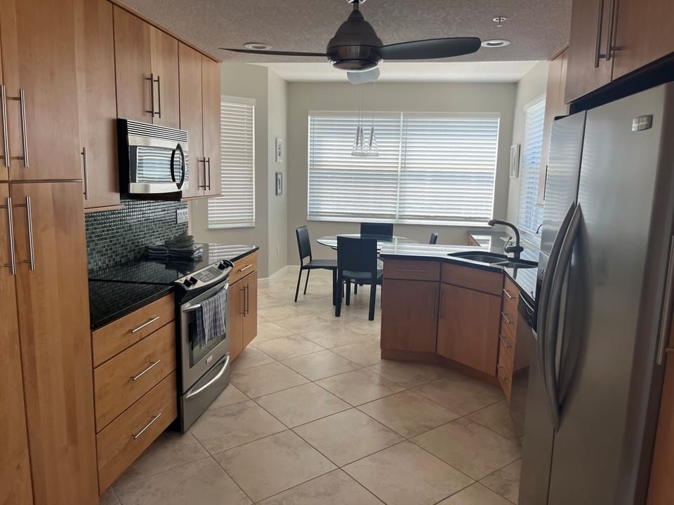 Kitchen area.  Eat in breakfast area at front of condo.  View of canal.