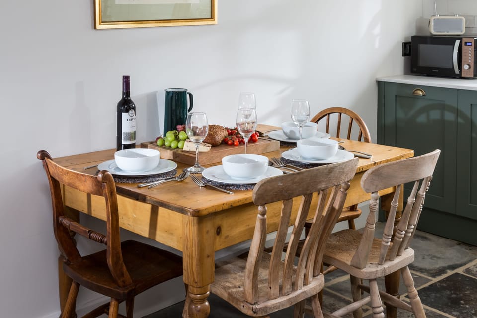 The rustic dining table complements the contemporary appliances in the kitchen