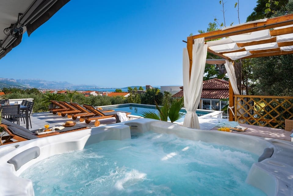 Private hot tub that overlooks pool area