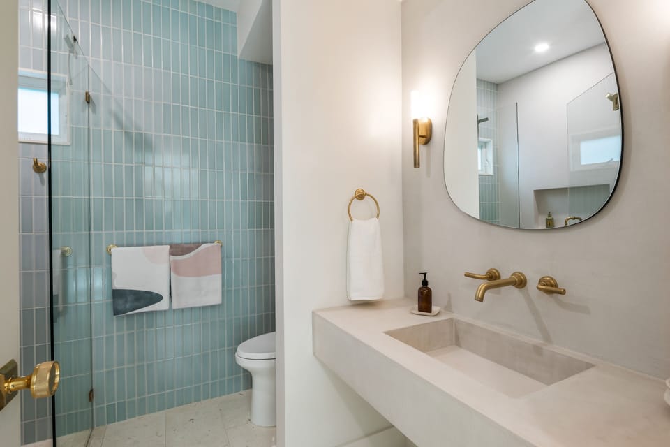 Pristine first floor bath with walk-in glass shower.