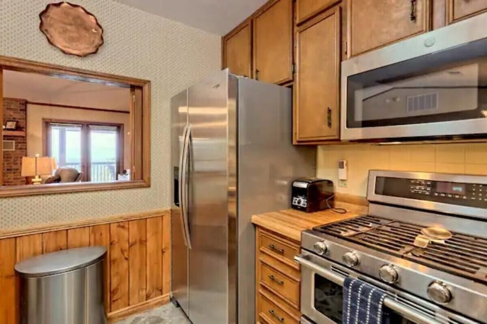 Upstairs kitchen with dishwasher and gas stove with double oven.