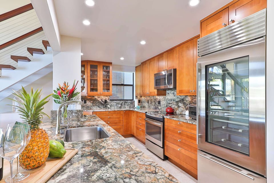Create family feasts in this stunning Maui kitchen, fully equipped with high-end appliances, granite counters, and ample space. Perfect for cooking meals together, saving money, and enjoying fresh island flavors right from your own vacation home.
