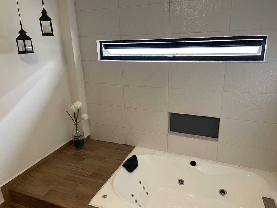 Deluxe 1 King Bed and Hot Tub | Iron/ironing board (on request), WiFi (free), bed sheets