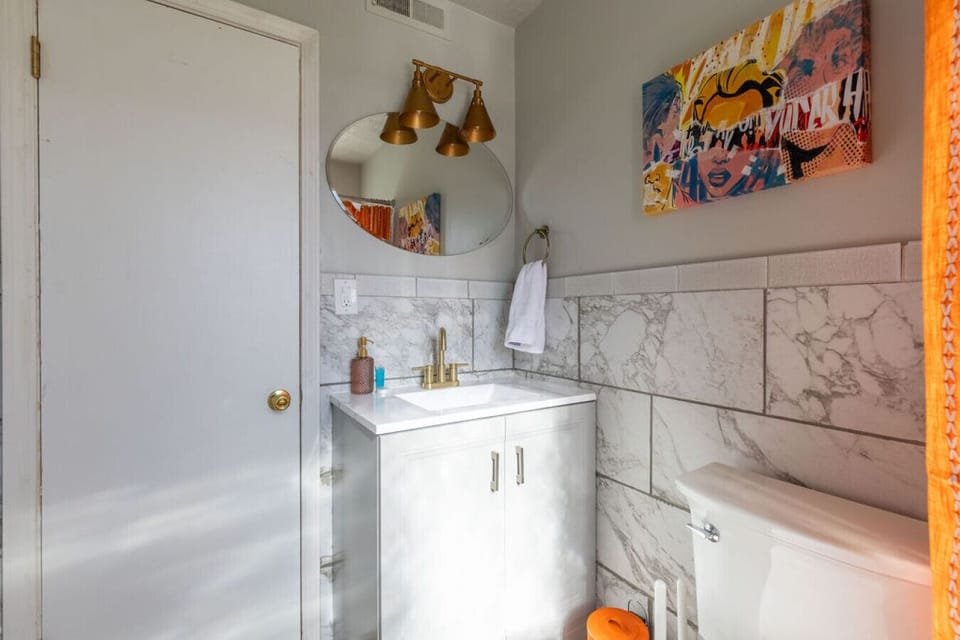 Freshen up in style with a bright, modern sink and mirror.