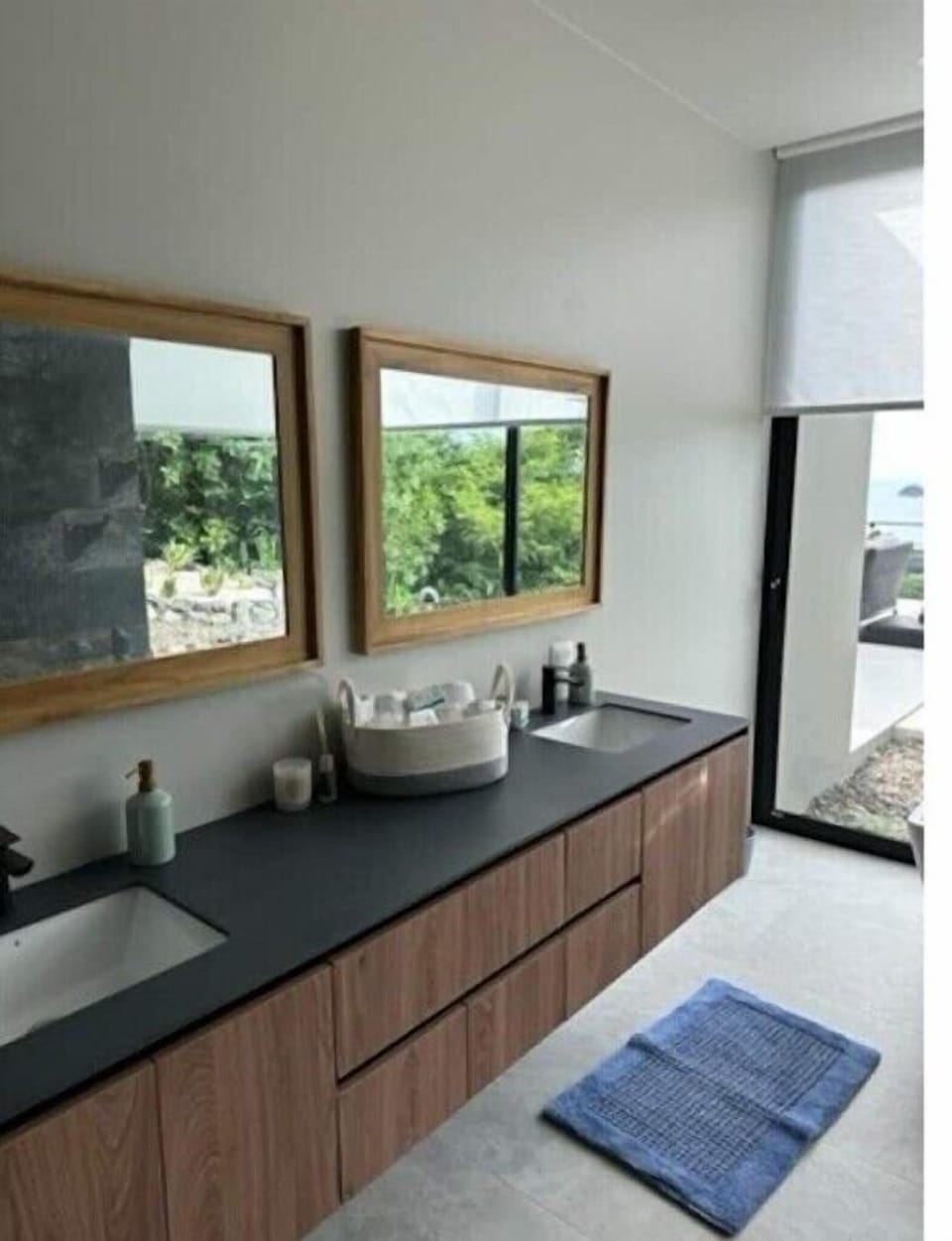 Master bathroom with double vanity with floor to ceiling glass windows.