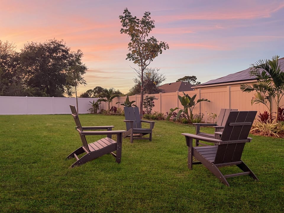 [Backyard Garden] 4 Adirondack chairs in the tropical garden for evening conversation