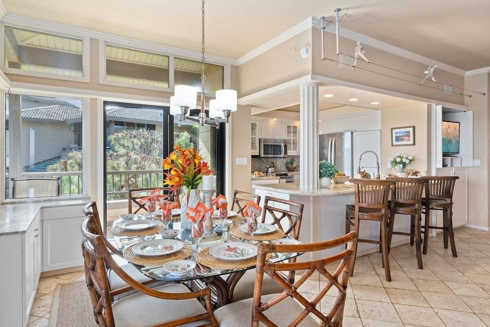 Bright open dining space with island-style furnishings, ceiling lighting, and a relaxing coastal ambiance perfect for shared meals.