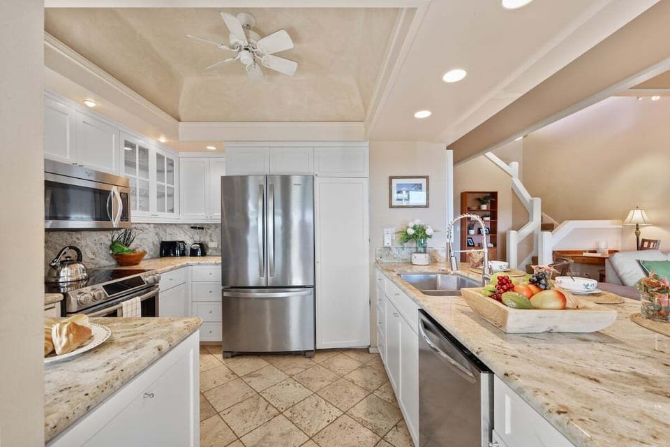 Fully remodeled kitchen featuring stainless appliances, granite counters, and ample prep space for effortless island-style cooking.