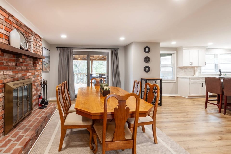 The dining room overlooks the screened in porch (non-working decorative fireplace).