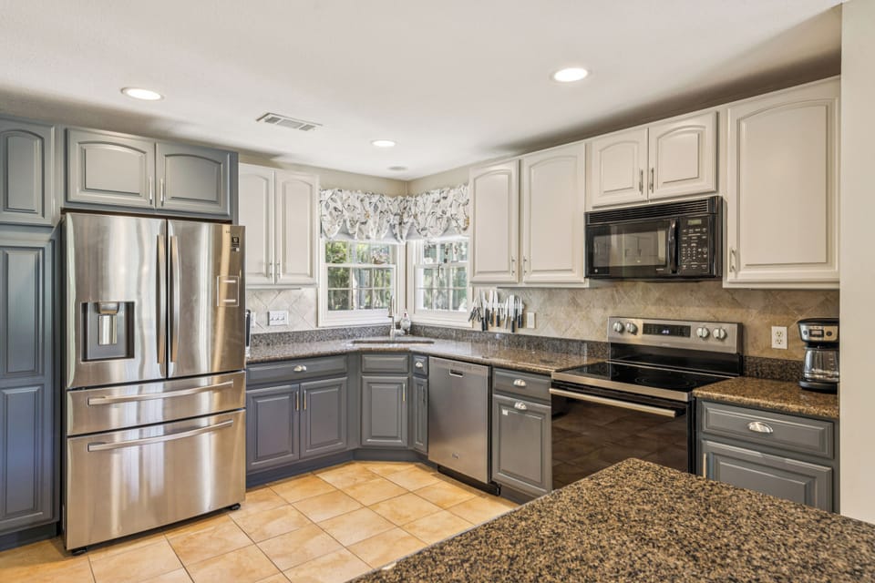 Kitchen with stainless steel appliances and is fully stocked.