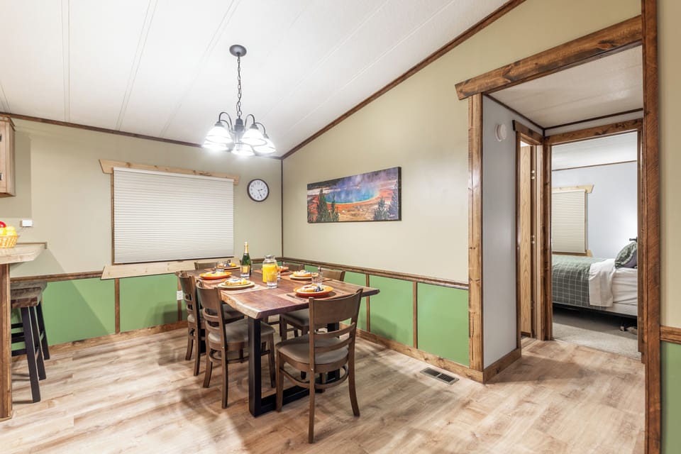 Gather around this rustic dining table for meals, games, or laughs—perfectly placed between the kitchen and cozy bedrooms for effortless connection.