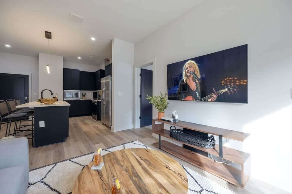 Bright living room with comfortable seating, pull out sofa, smart TV, complete with designer decor.
