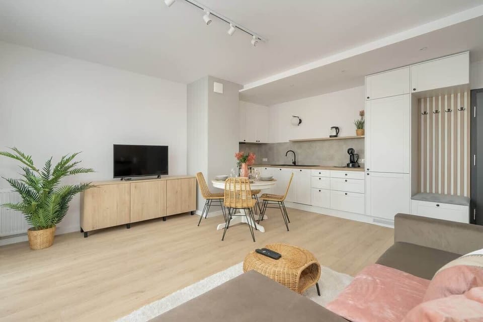A harmonious layout featuring a spacious living room connected to the dining area, with a neutral color palette and soft lighting.


