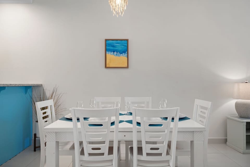 Swish Dining Area of the 2BR Condo in Noord Aruba - 6 Persons Dining - Elegant chandelier and lighting - Thoughtfully curated decor adding personality