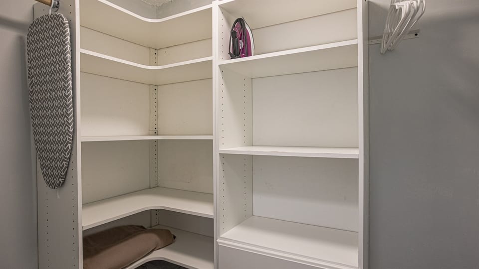 Closet with iron/ironing board and hangers