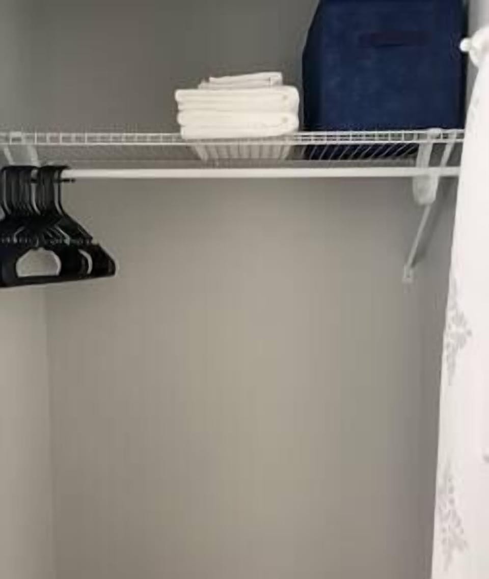 Bedroom closet with iron and ironing board