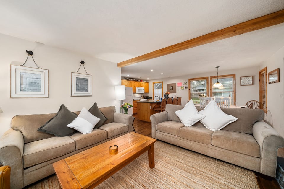 Living room with Electric fireplace, Smart TV, comfy furniture, Open to the dining room and fully equipped kitchen.