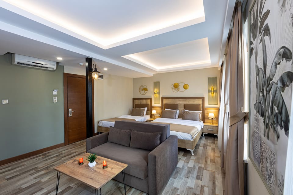 Deluxe Quadruple Room | Desk, laptop workspace, soundproofing, iron/ironing board