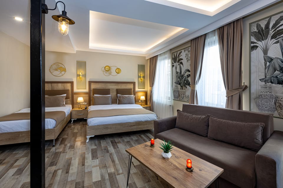 Deluxe Quadruple Room | Desk, laptop workspace, soundproofing, iron/ironing board