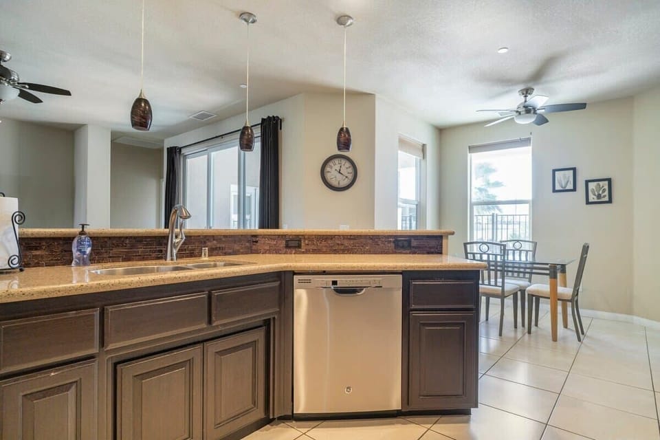Kitchen area with casual dining area and view of the backyard