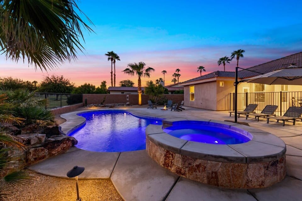 Sunset by the pool and spa with multi-color lights
