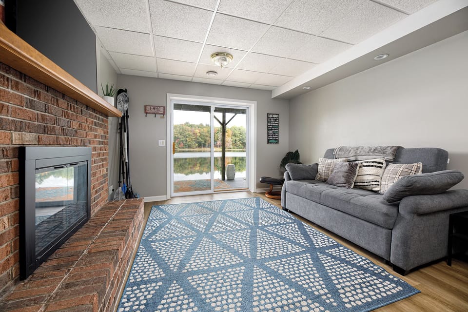 Relax in the bright living room w/ plush sofa sleeper, fireplace, & sliding doors to the deck.