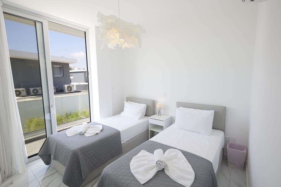 Bedroom 3 with two single beds and balcony access