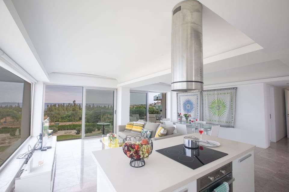 Kitchen and living room with patio doors leading to the large balcony