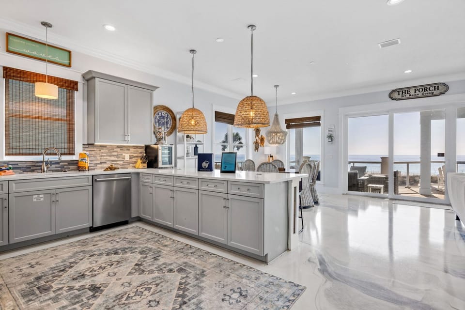 Your spacious kitchen features granite counters, stainless appliances, and wicker pendant lights, creating the perfect space for cooking and gathering.