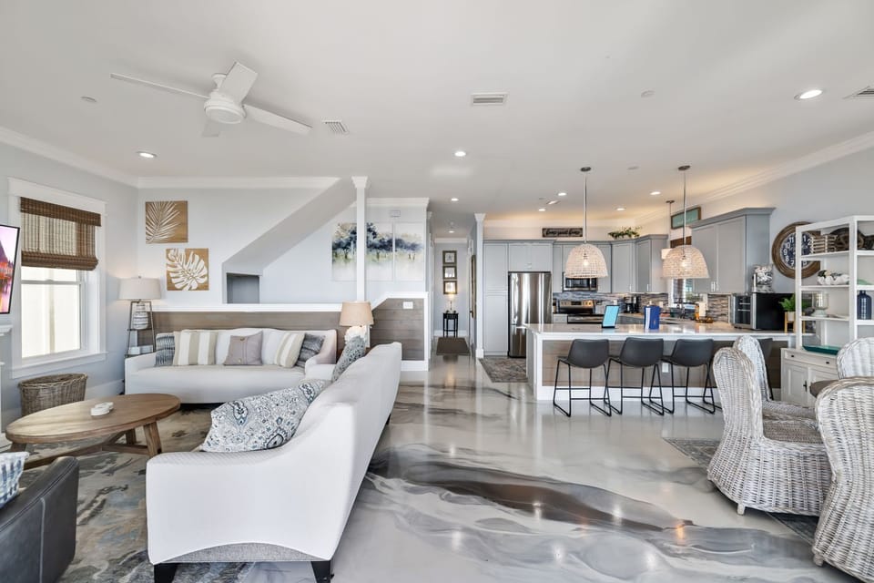 Unwind in this stunning open-concept space where coastal elegance meets comfort. Sink into plush seating while natural light dances across polished floors.