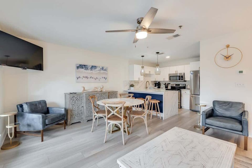 - Host dinners, hang out, or cook up a storm in this stylish open concept space - Features a full kitchen, cozy chairs, and a central island with bar seating - Bright wood floors, pendant lights, and charming touches make it feel just like home